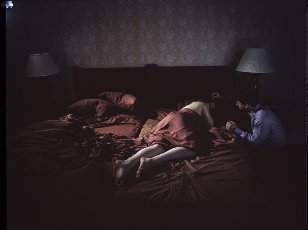 After spending the night together, Karol (Zbigniew Zamachowski) watches Dominique (Julie Delpy) sleep.