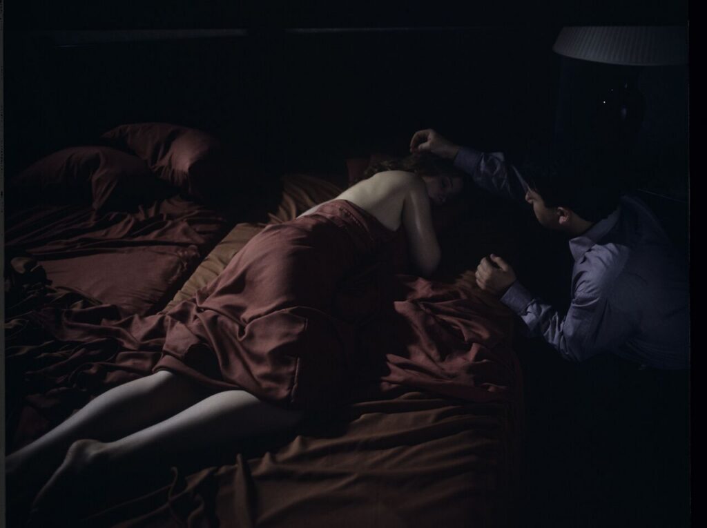 After spending the night together, Karol (Zbigniew Zamachowski) watches Dominique (Julie Delpy) sleep.