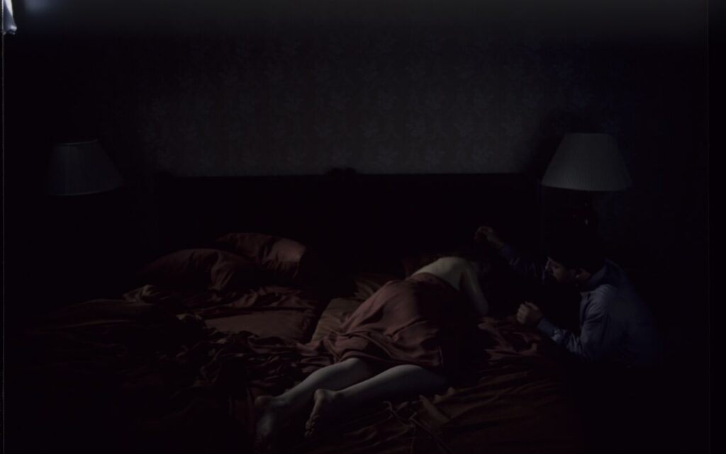 After spending the night together, Karol (Zbigniew Zamachowski) watches Dominique (Julie Delpy) sleep.