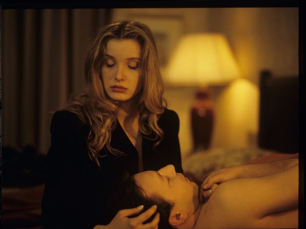 Dominique (Julie Delpy) returns to a hotel apartment after Karol's (Zbigniew Zamachowski) funeral, where she finds him alive