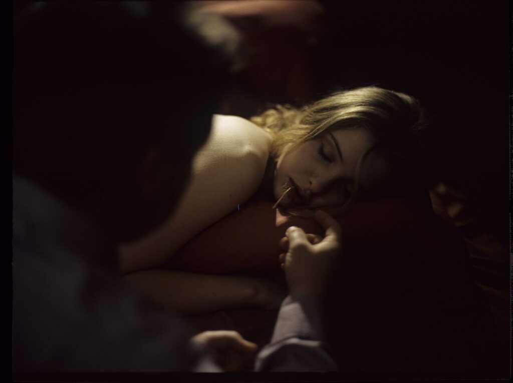 After spending the night together, Karol (Zbigniew Zamachowski) watches Dominique (Julie Delpy) asleep.