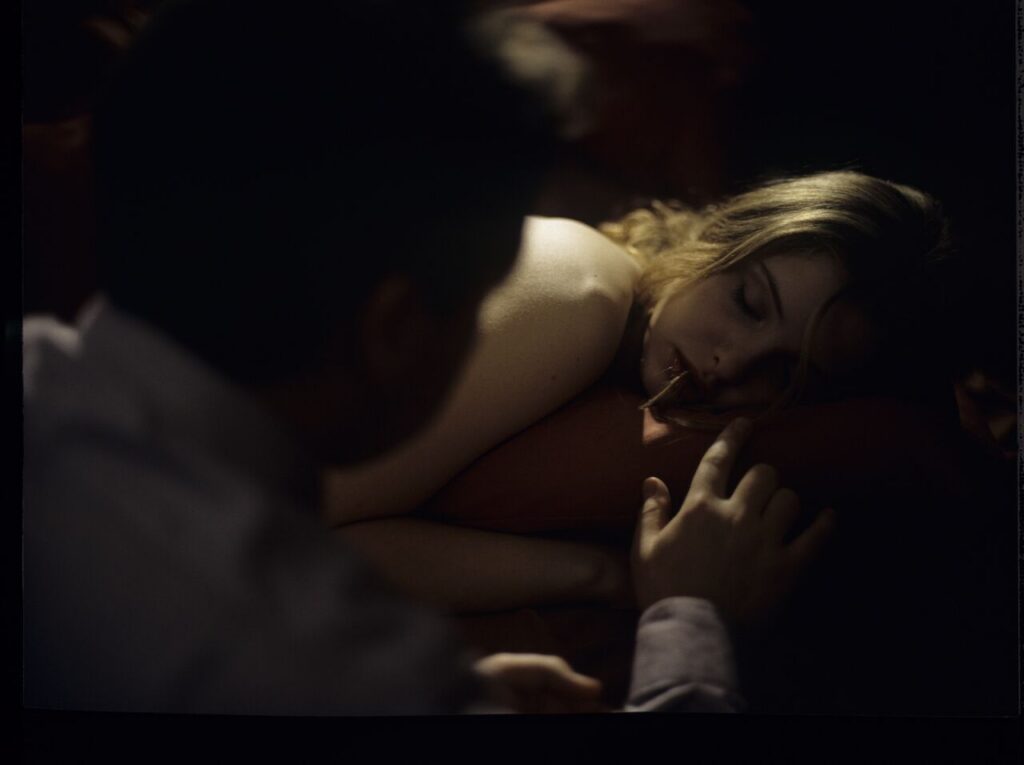 After spending the night together, Karol (Zbigniew Zamachowski) watches Dominique (Julie Delpy) asleep.