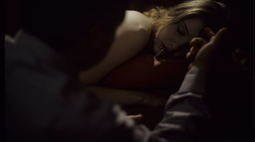 After spending the night together, Karol (Zbigniew Zamachowski) watches Dominique (Julie Delpy) asleep.