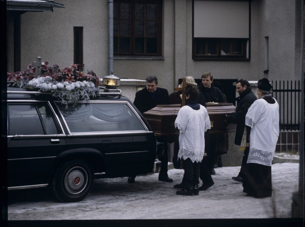 The funeral scene that Charles observes on the street near Nicholas's house.
