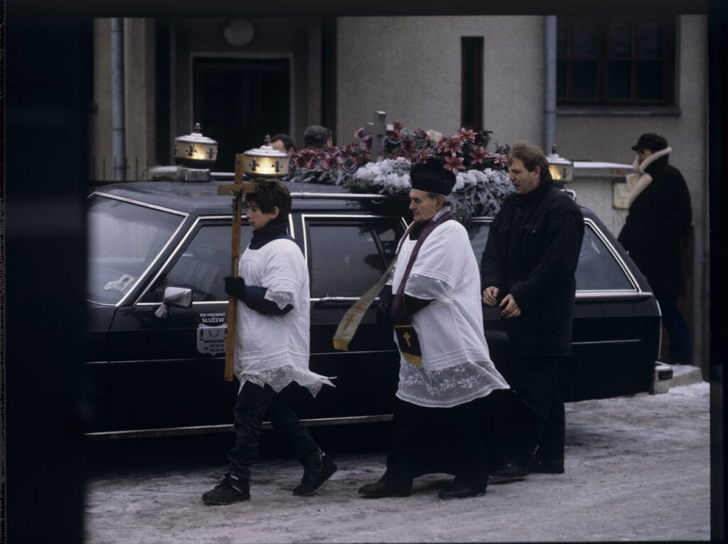 The funeral scene that Charles observes on the street near Nicholas's house.