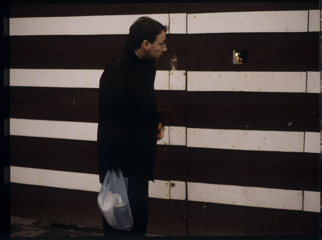 Karol (Zbigniew Zamachowski) by the prison gate.