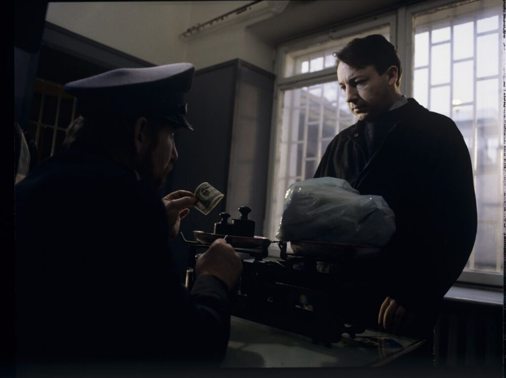 Karol (Zbigniew Zamachowski) is giving a prison guard a package for his ex-wife Dominique.