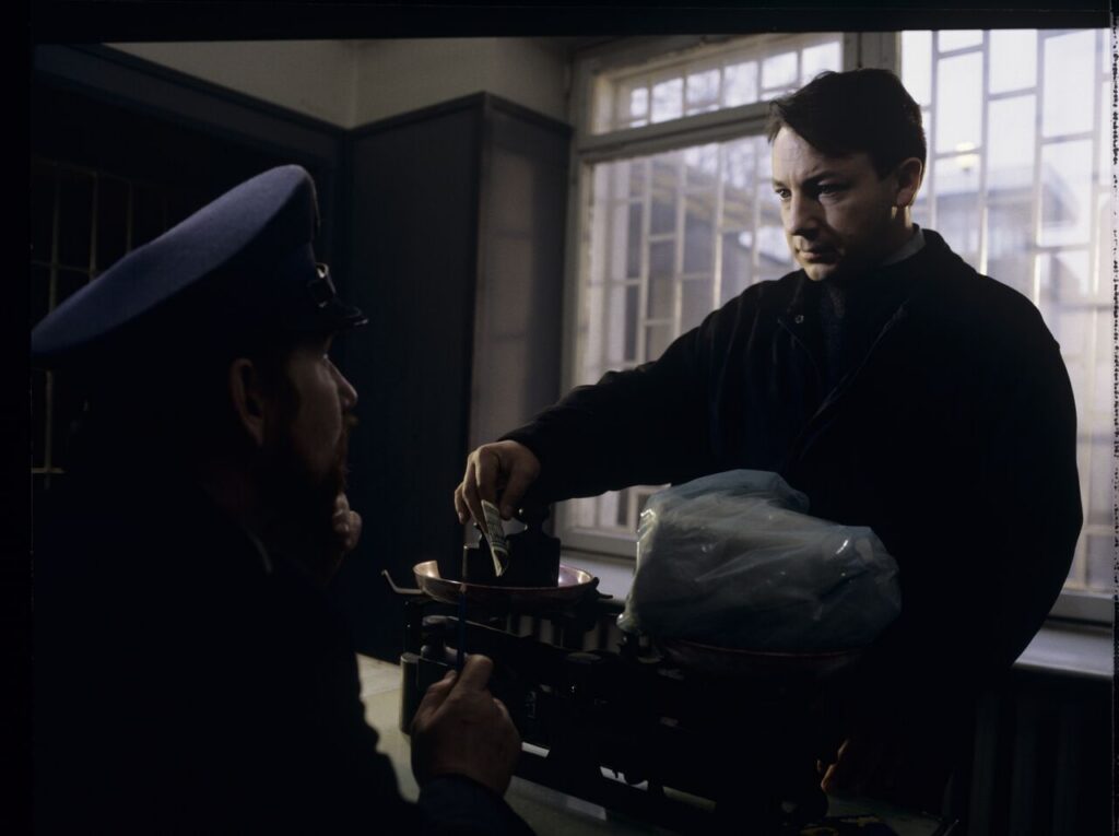 Karol (Zbigniew Zamachowski) is giving a prison guard a package for his ex-wife Dominique.