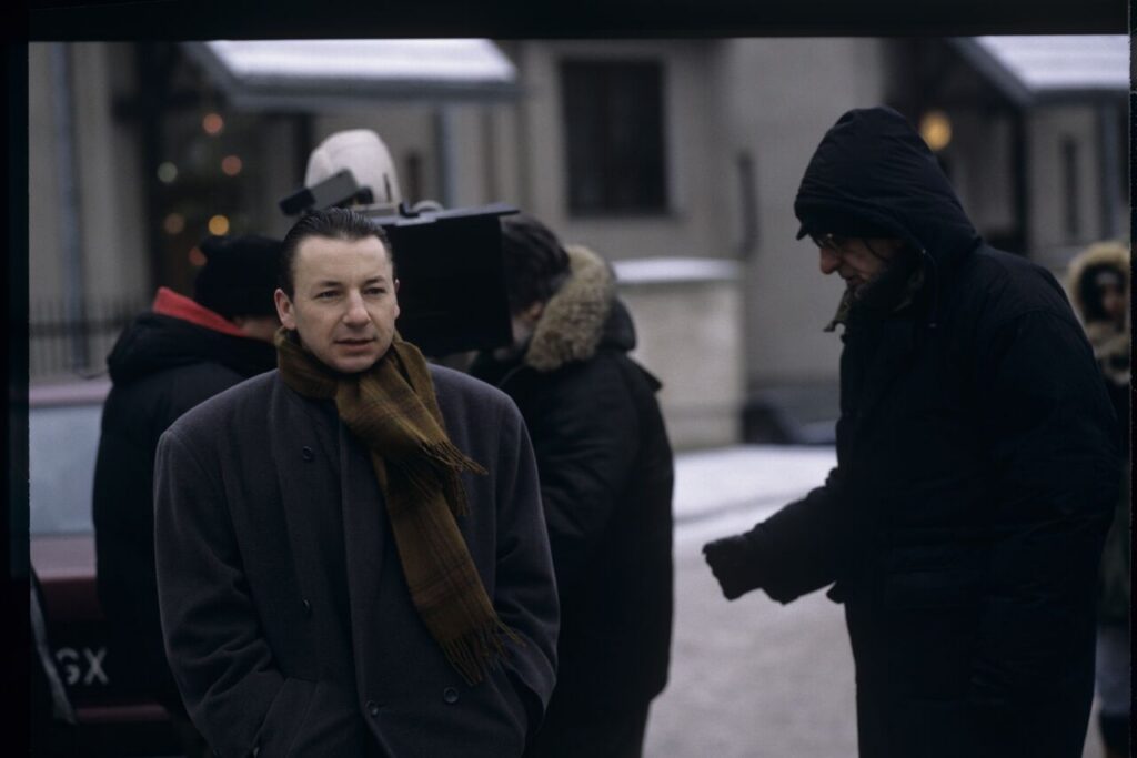 Zbigniew Zamachowski as Karol and others on the set outside Mikołaj's house.