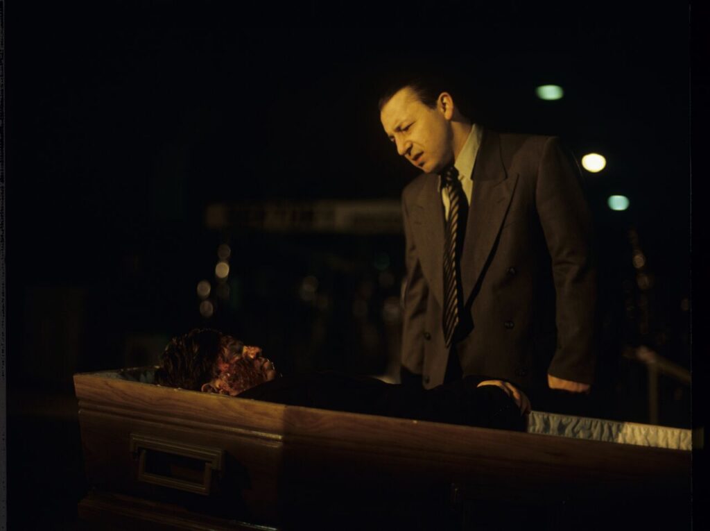 Karol (Zbigniew Zamachowski) looks at a "purchased" corpse that is supposed to make his faked death credible.