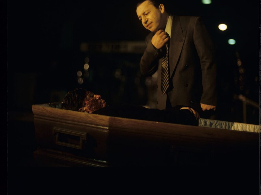 Karol (Zbigniew Zamachowski) looks at a "purchased" corpse that is supposed to make his faked death credible.