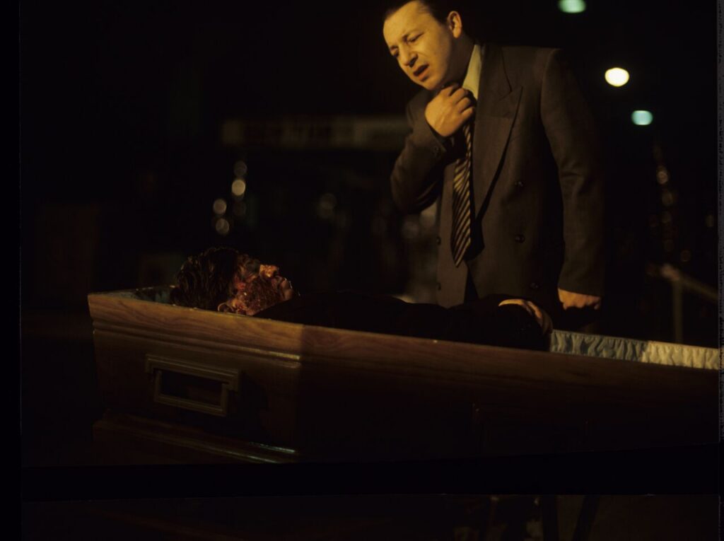 Karol (Zbigniew Zamachowski) looks at a "purchased" corpse that is supposed to make his faked death credible.