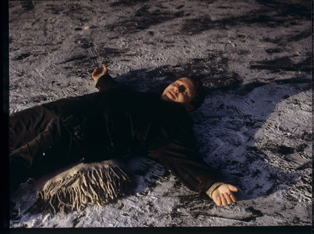 Karol (Zbigniew Zamachowski) in the scene of sliding on frozen Wisła river.
