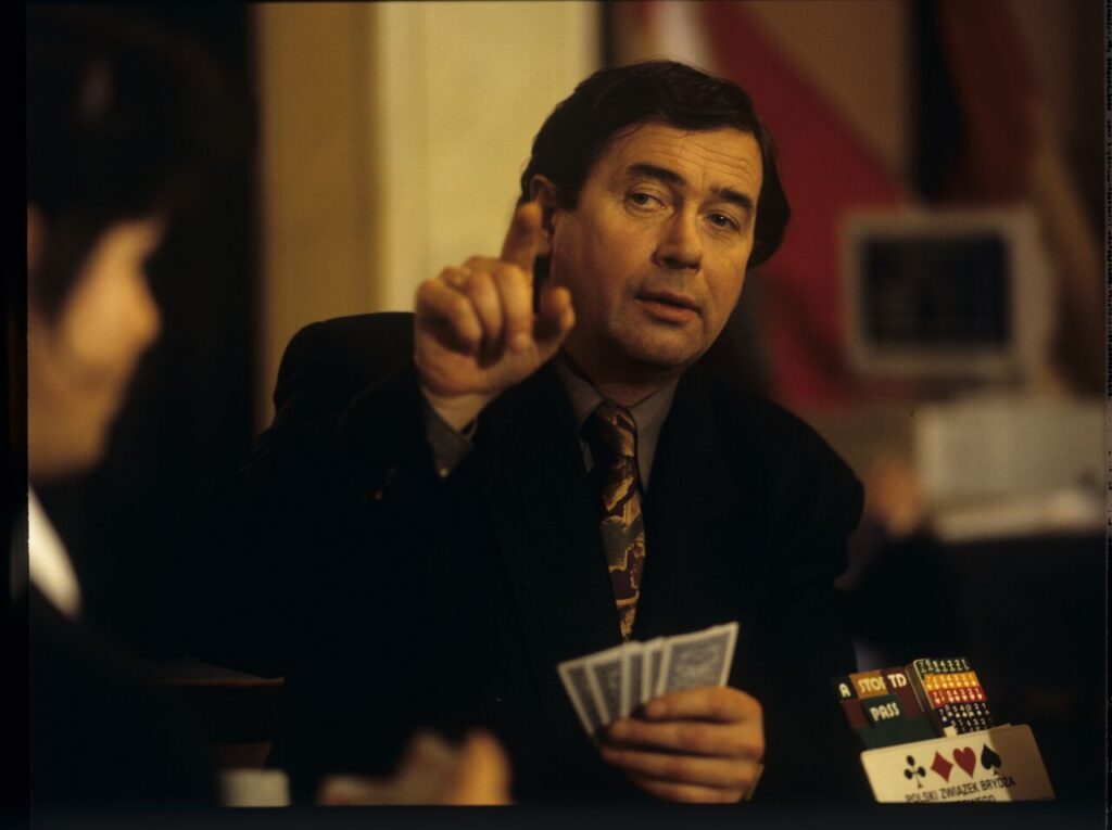 Janusz Gajos (playing the role of Mikołaj) at the card table where Karol found him.