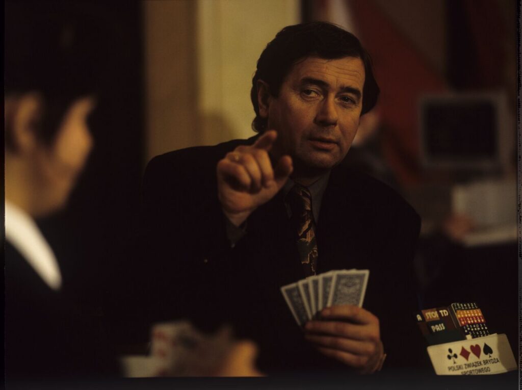Janusz Gajos (playing the role of Mikołaj) at the card table where Karol found him.