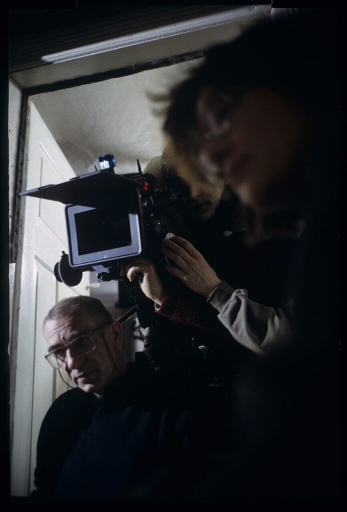 Krzysztof Kieślowski (director) and others during filming a scene.