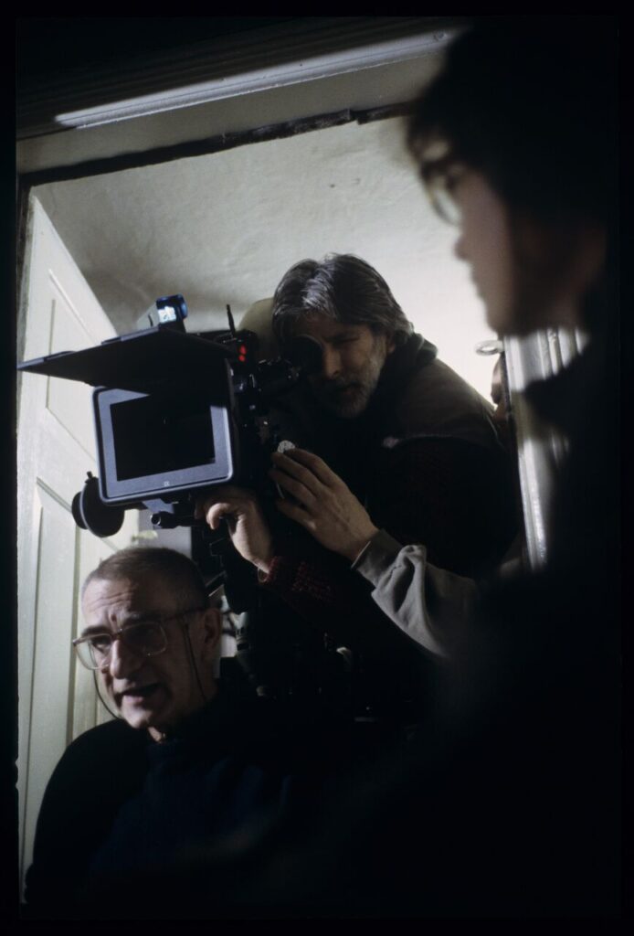Krzysztof Kieślowski (director) and others during filming a scene.