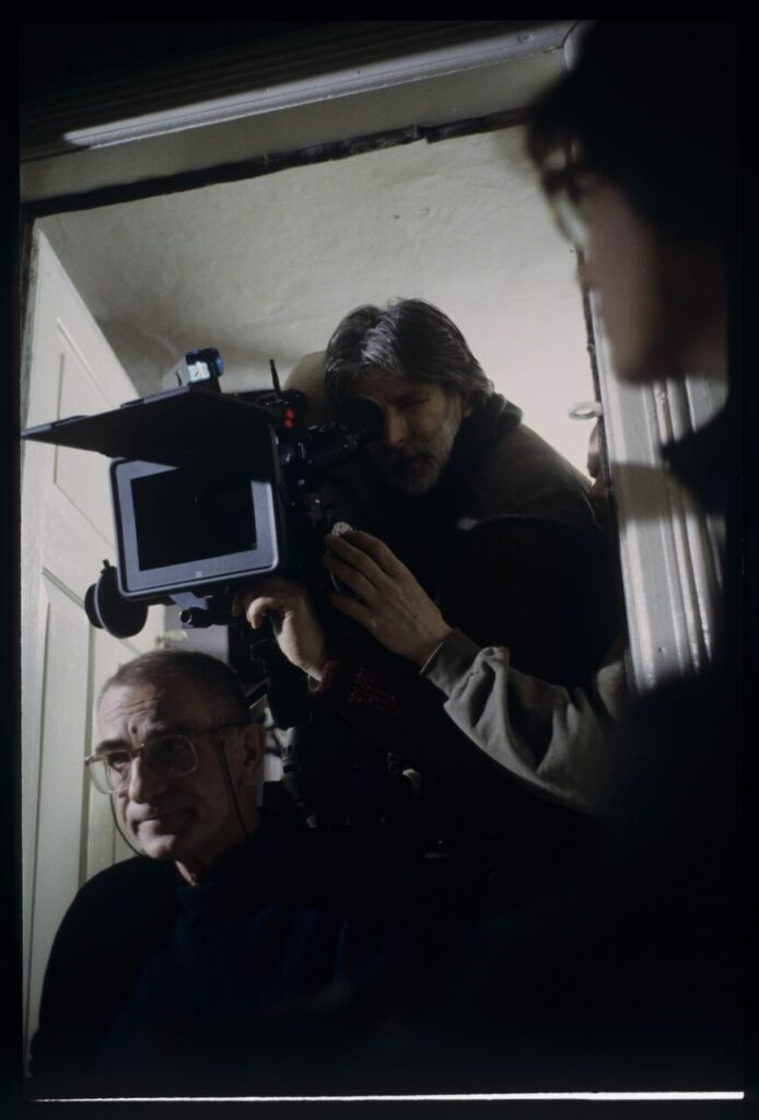 Krzysztof Kieślowski (director) and others during filming a scene.