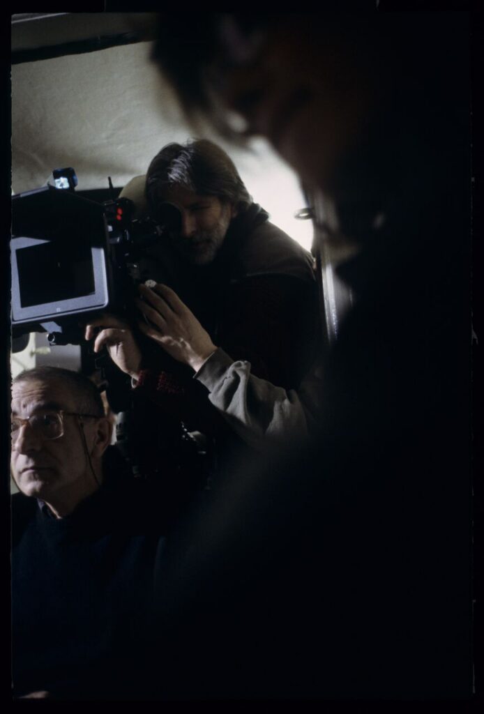 Krzysztof Kieślowski (director) and others during filming a scene.