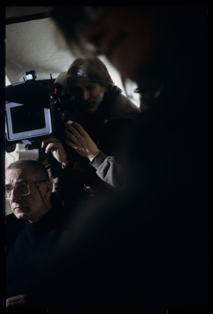 Krzysztof Kieślowski (director) and others during filming a scene.
