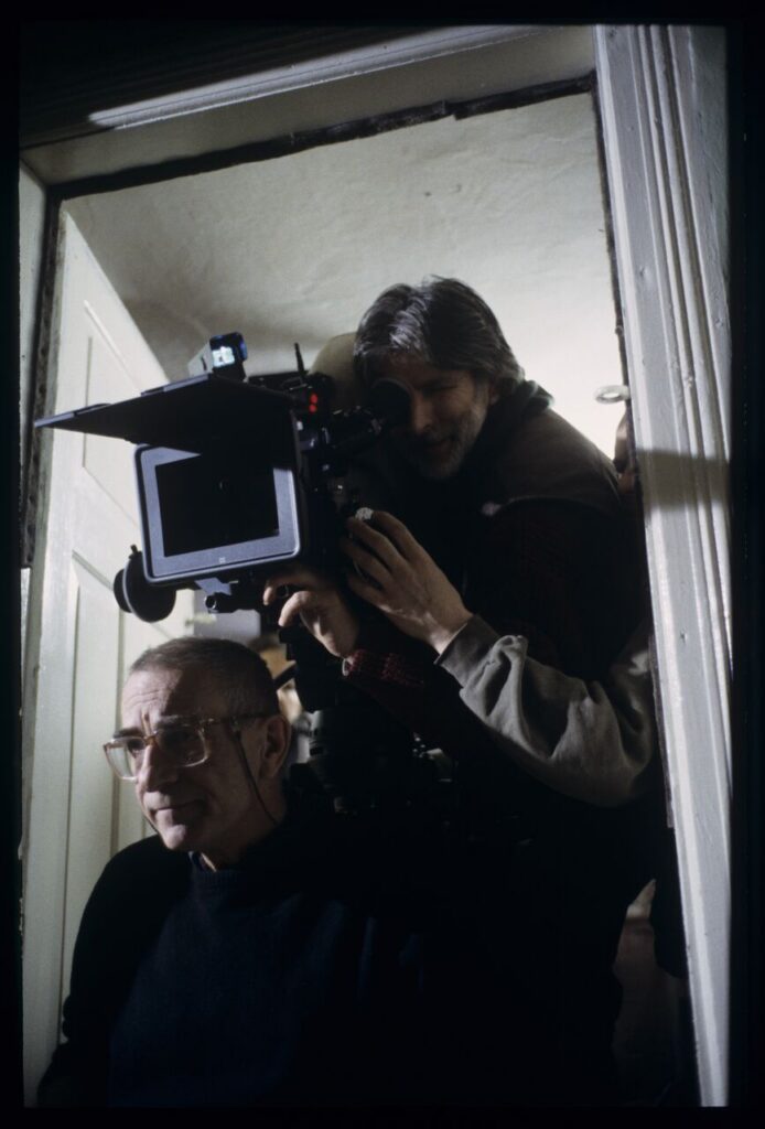 Krzysztof Kieślowski (director) and others during filming a scene.