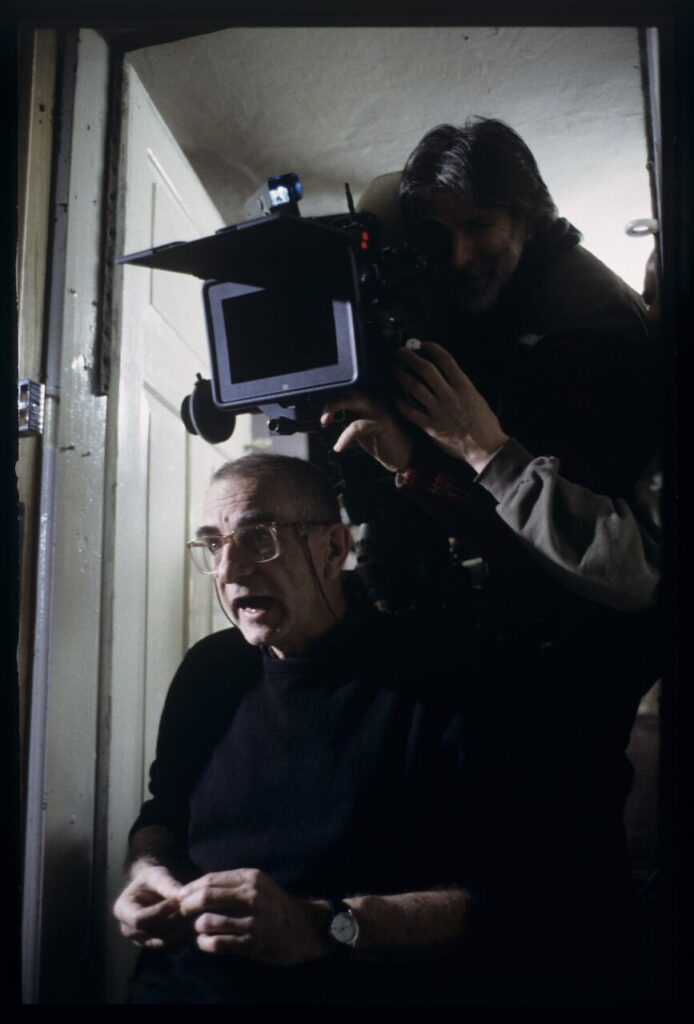Krzysztof Kieślowski (director) and others during filming a scene.