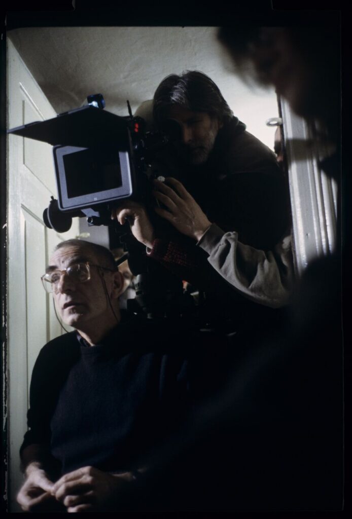 Krzysztof Kieślowski (director) and others during filming a scene.