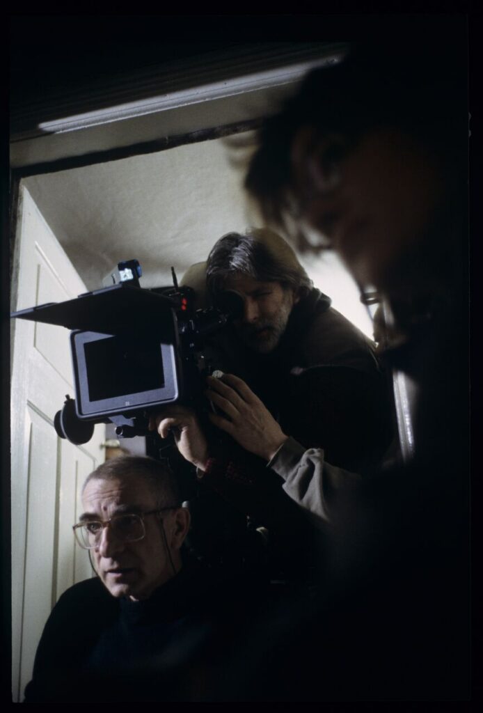 Krzysztof Kieślowski (director) and others during filming a scene.