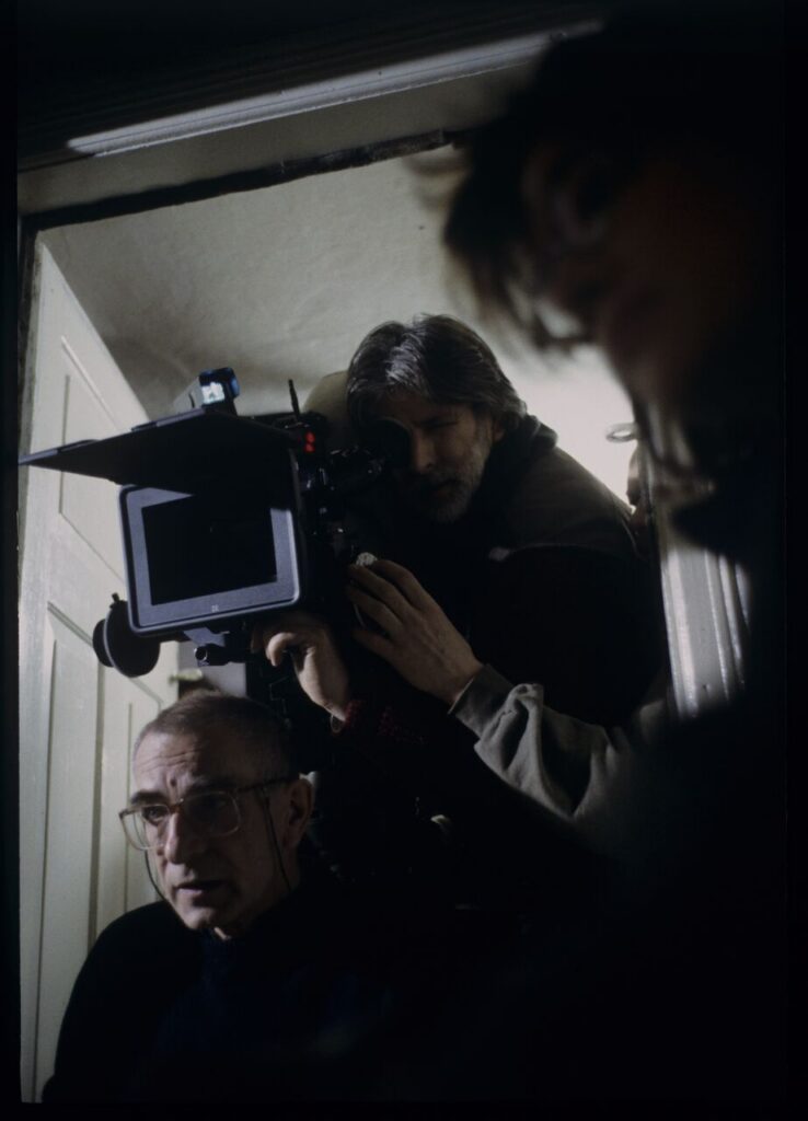 Krzysztof Kieślowski (director) and others during filming a scene.