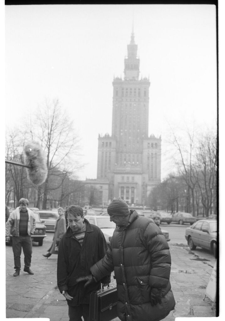 K. Kieślowski (director) and Z. Zamachowski (playing Karol) on the set near the Palace of Culture and Science in Warsaw.