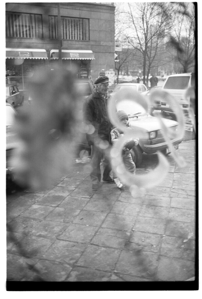 A Warsaw street seen through the window of a liquor store.
