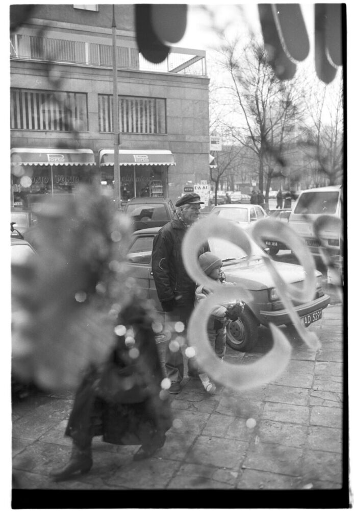 A Warsaw street seen through the window of a liquor store.