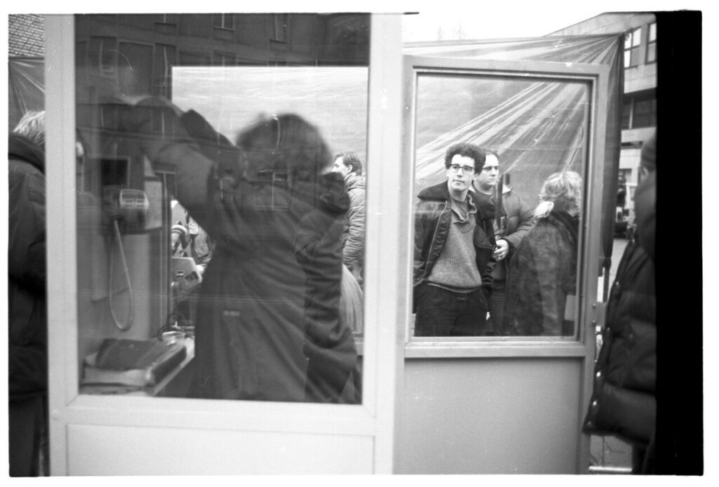 The crew is preparing a set at a telephone booth.