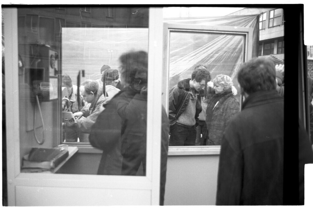 The crew is preparing a set at a telephone booth.