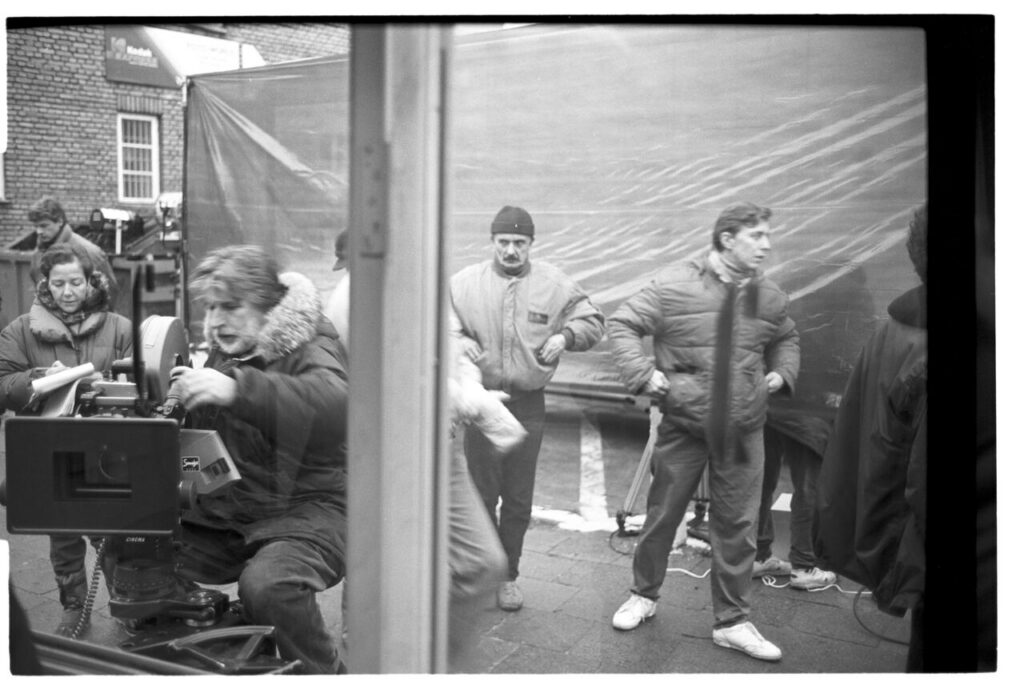 Edward Kłosiński (cameraman) and others along with technicians on set at a telephone booth.