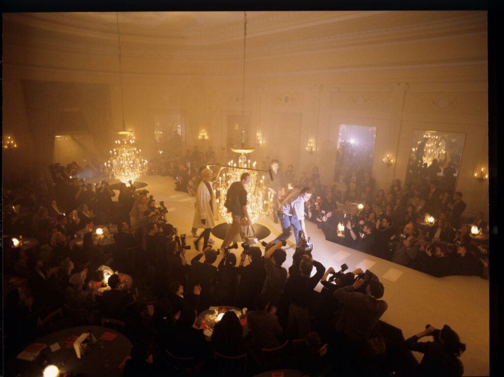 Filming a fashion show scene at a theater.