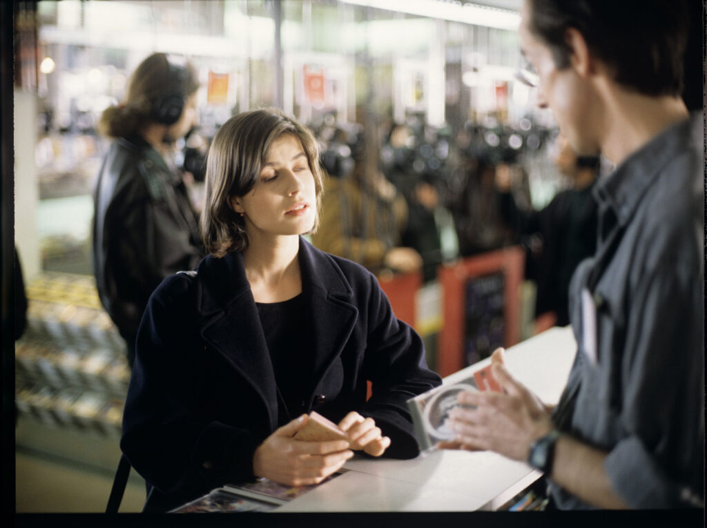 Valentine (Irène Jacob) while shopping at a music store.