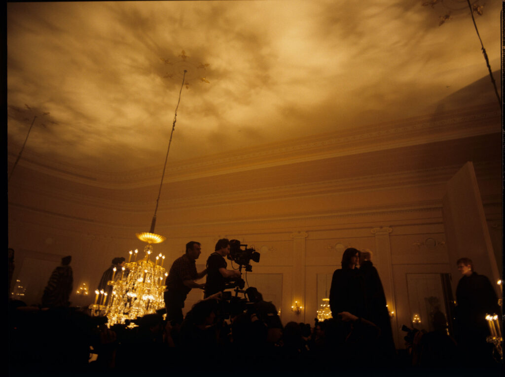 Filming a fashion show scene at a theater.