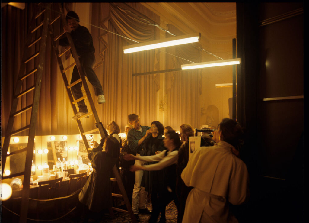 Filming a fashion show scene at a theater.
