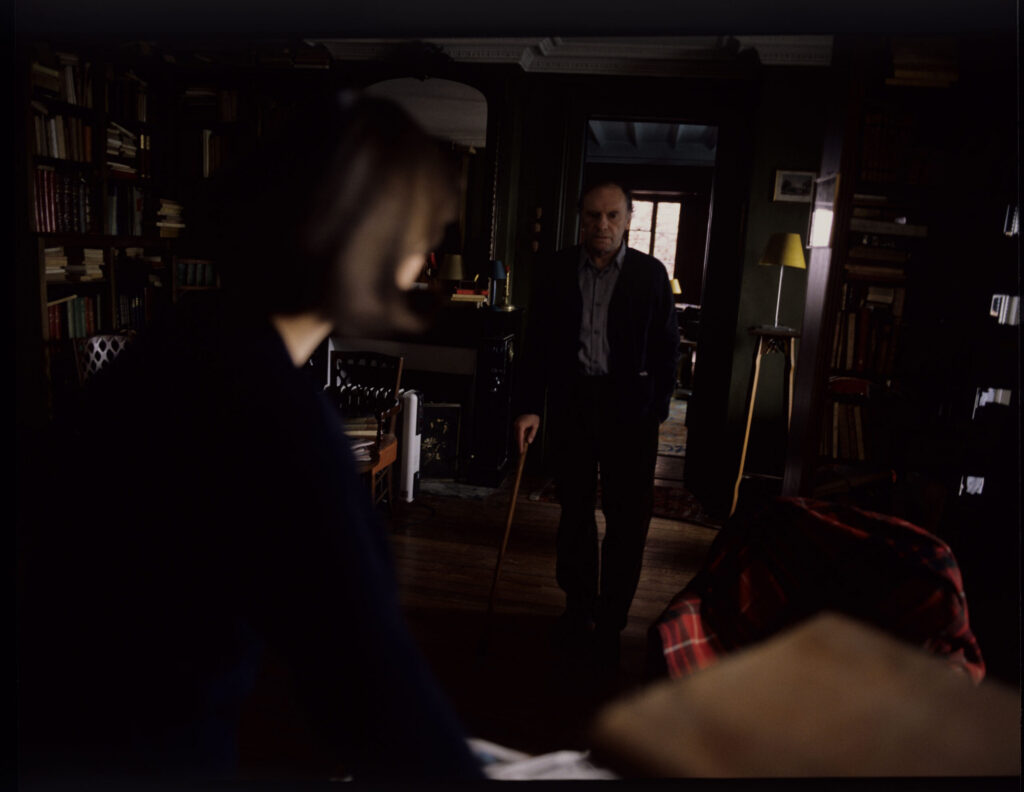 Retired judge Joseph Kern (Jean-Louis Trintignant) talks to Valentine (Irène Jacob) in his apartment.