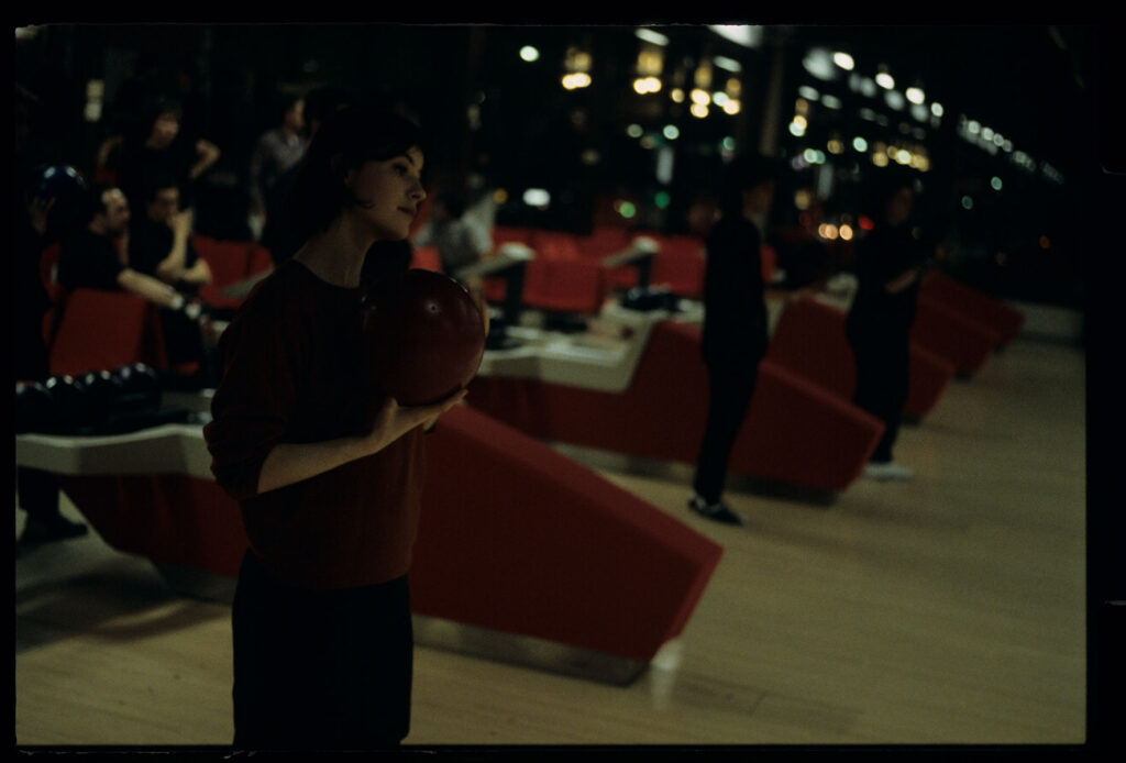 The main character of the film Valentine (Irène Jacob) in a bowling alley.