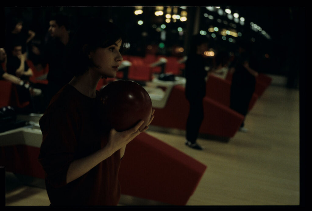 The main character of the film Valentine (Irène Jacob) in a bowling alley.