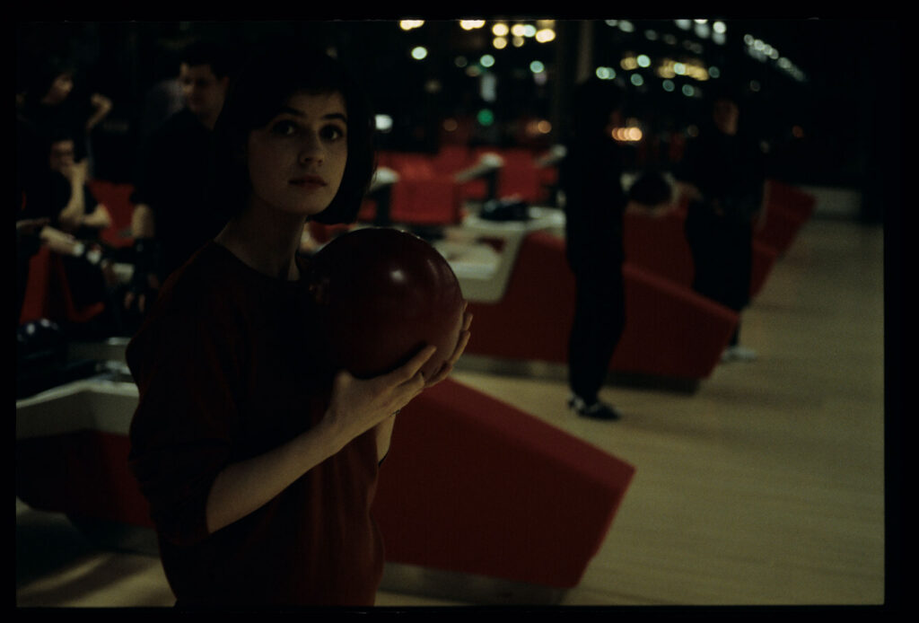The main character of the film Valentine (Irène Jacob) in a bowling alley.
