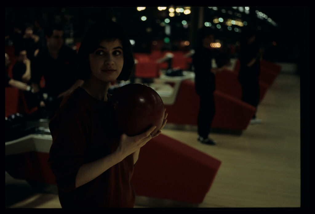 The main character of the film Valentine (Irène Jacob) in a bowling alley.
