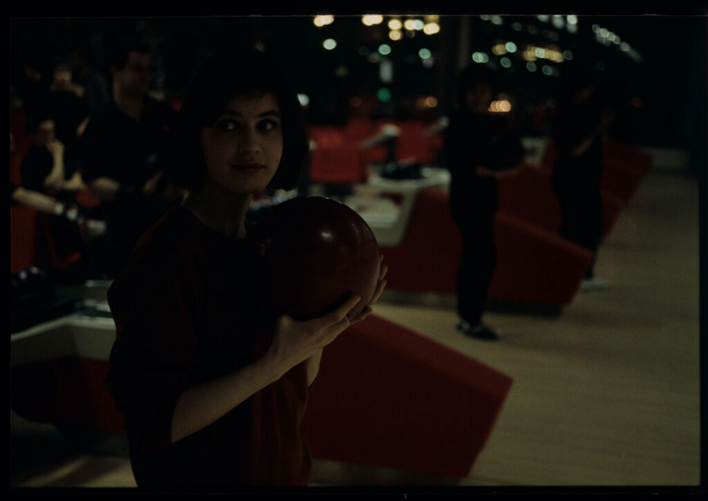 The main character of the film Valentine (Irène Jacob) in a bowling alley.