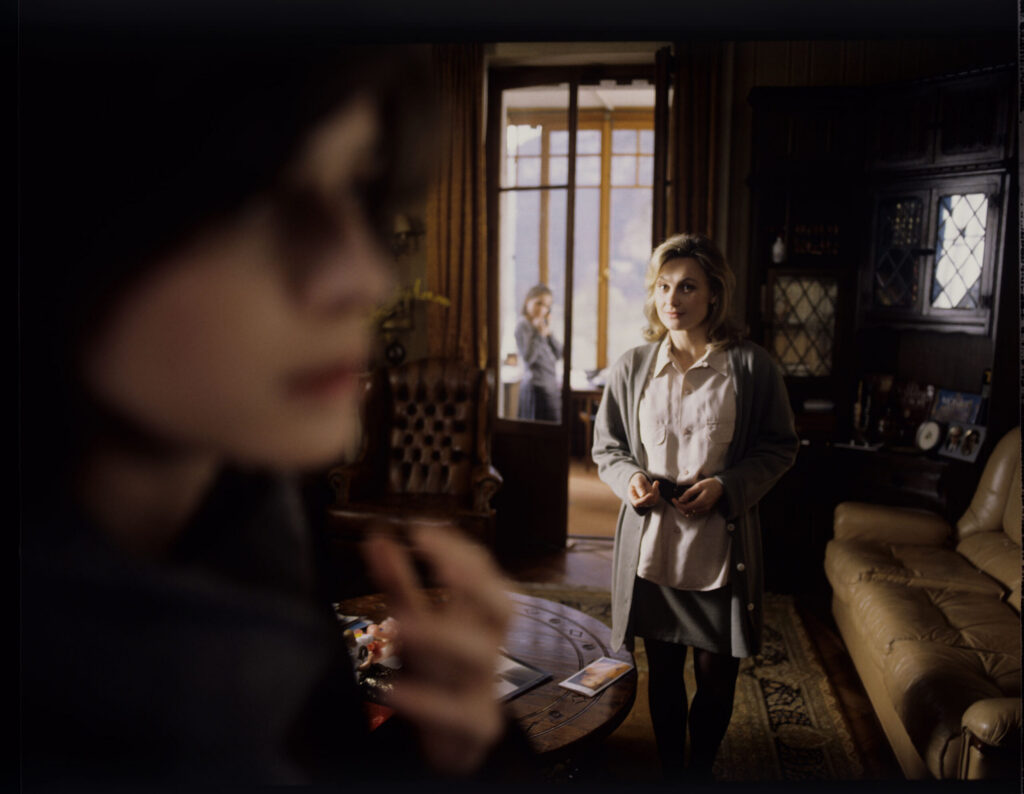 Valentine (Irène Jacob) informs the judge's neighbor that the judge is listening to her husband's telephone conversations.