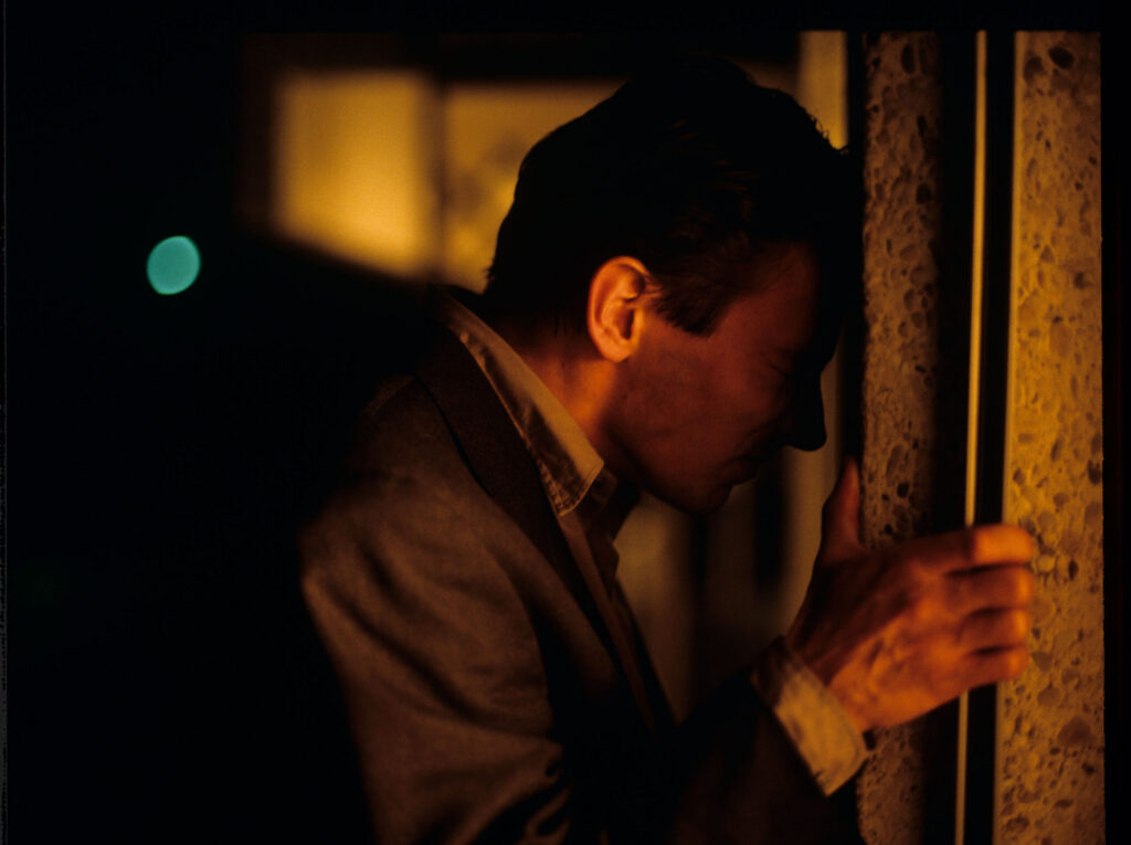 Auguste (Jean-Pierre Lorit) watching his partner with another man.