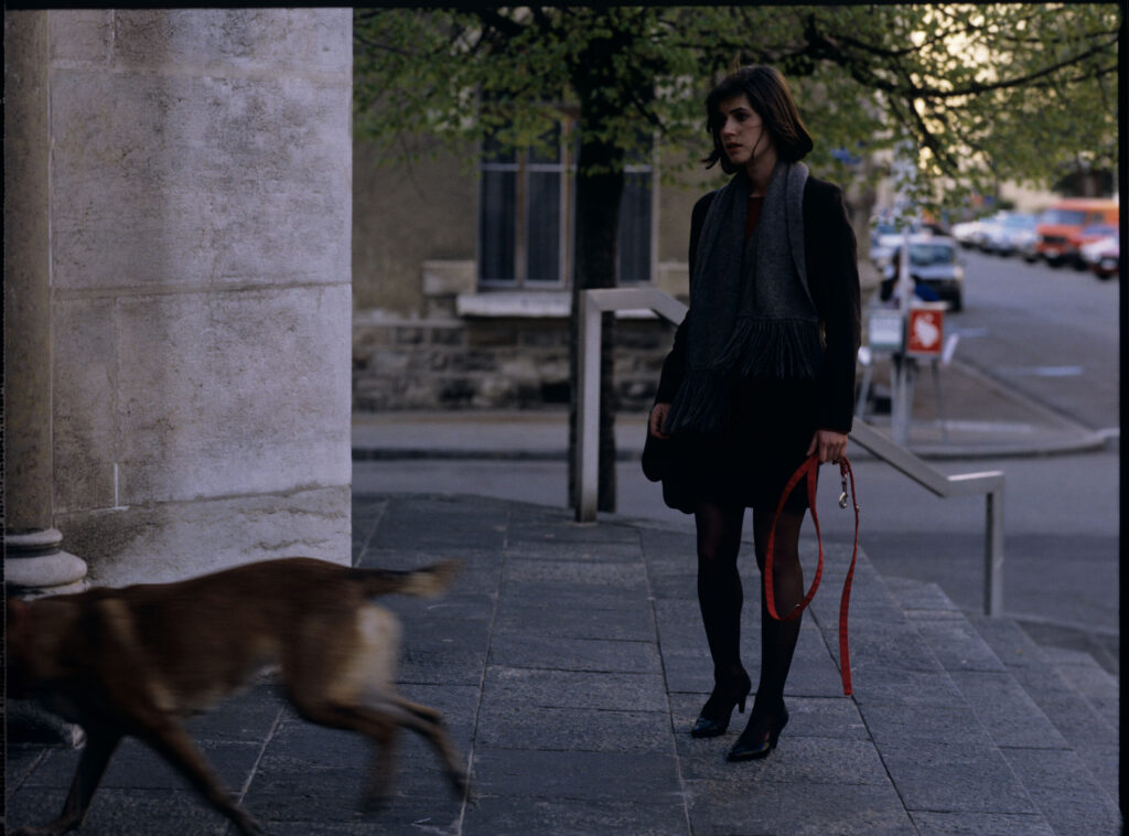 Valentine (Irène Jacob) walking her dog.