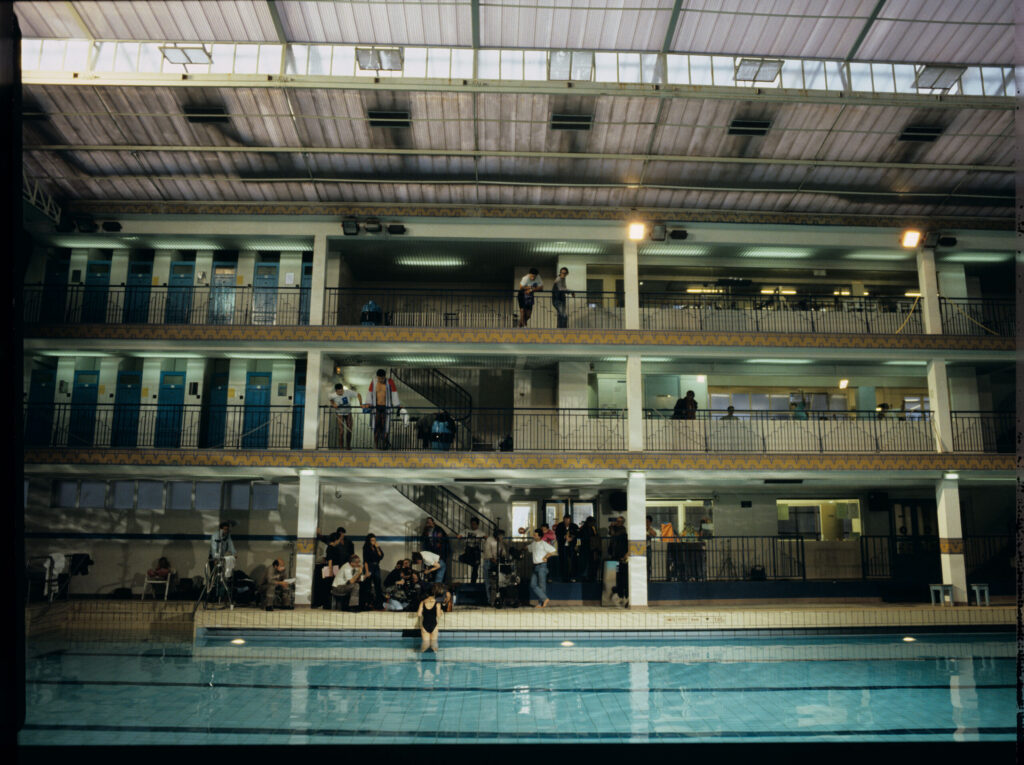 The crew is on set at the swimming pool, where Julie often swims to relieve her emotions.