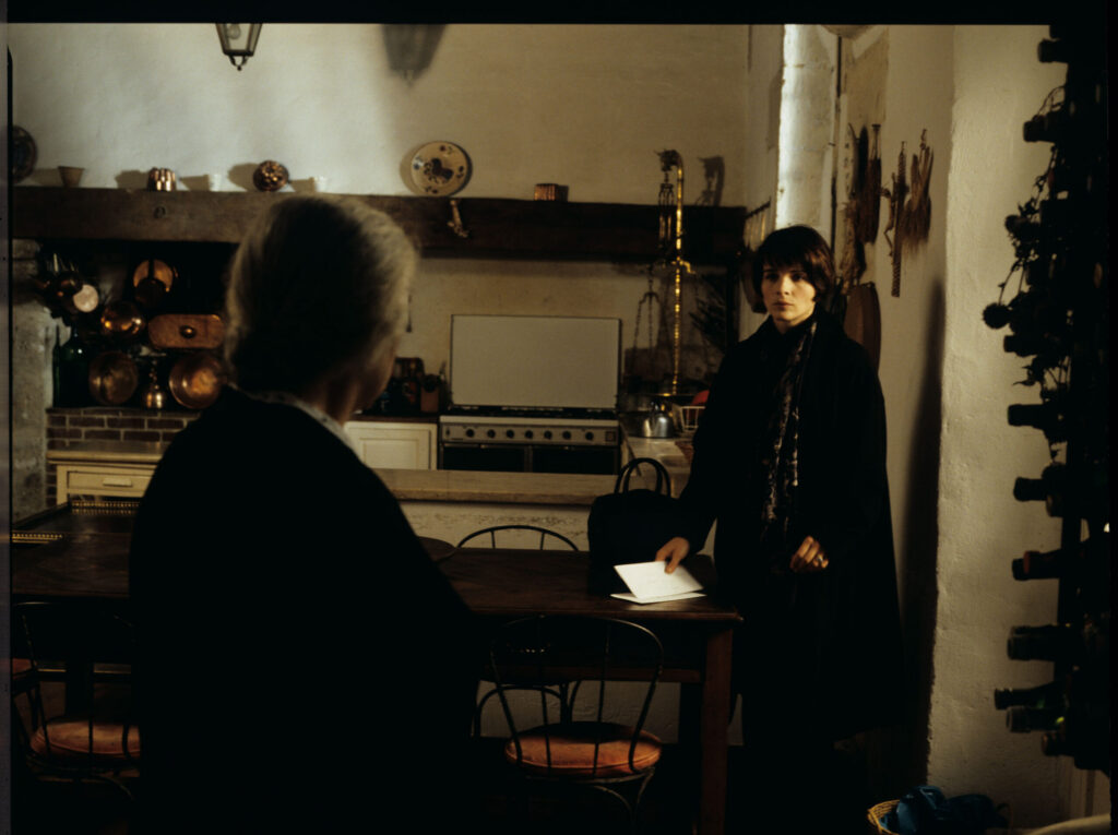 Julie (Binoche), after leaving the hospital, talks to a maid (Isabelle Sadoyan) in the kitchen of her mansion outside Paris.